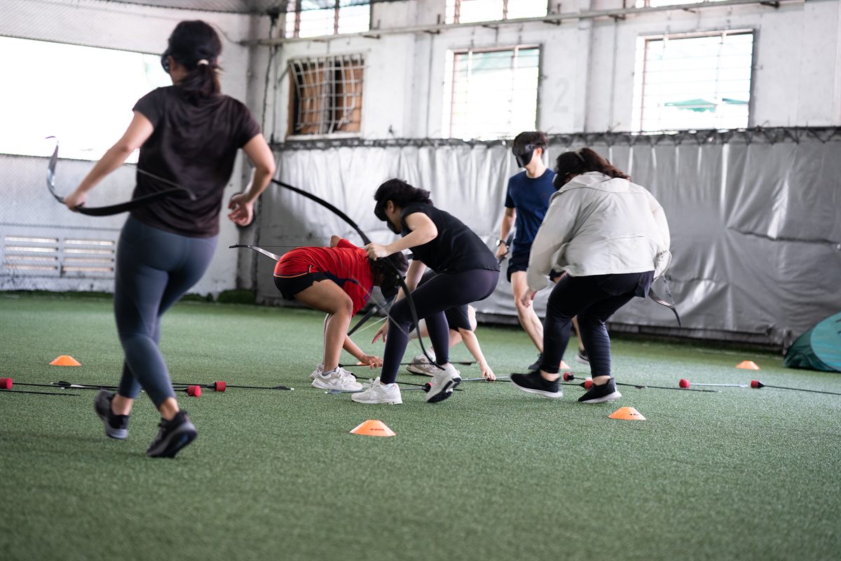 Archery Tag team building players with foam-arrow equipment