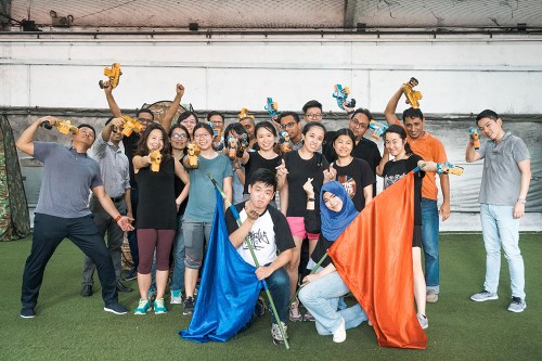 Laser Tag team holding Cohesion equipment after a game