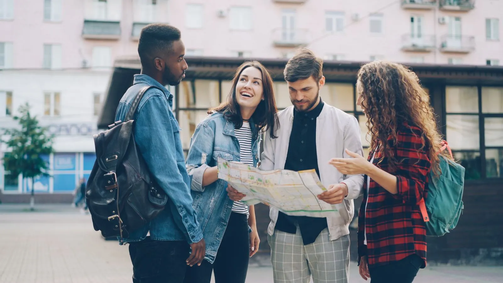 Illustrative photo of friends navigating a city with a paper map