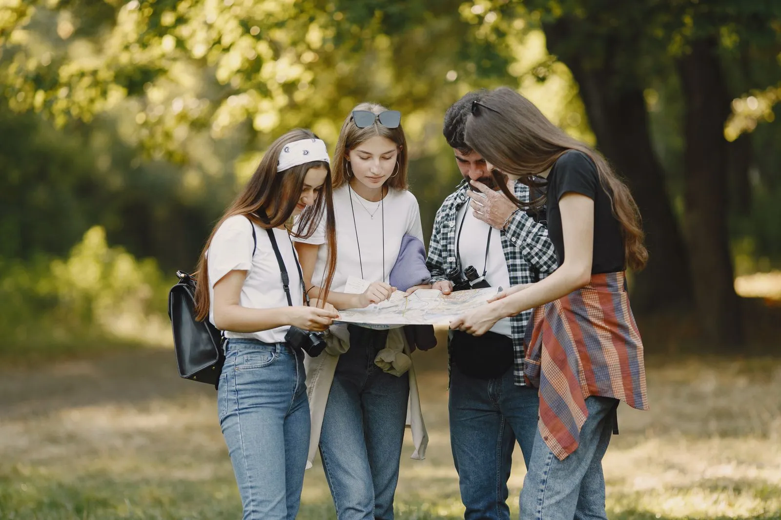 Illustrative photo of a group planning a route with a map outdoors