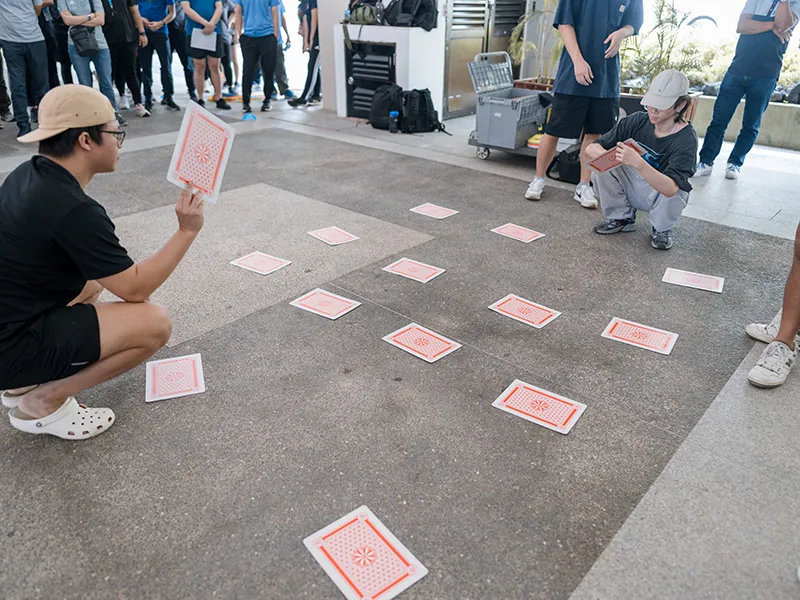 Participants completing a quick station challenge during a Cohesion team event