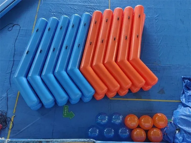 Blue and orange inflatable hockey sticks and balls laid out on a blue floor