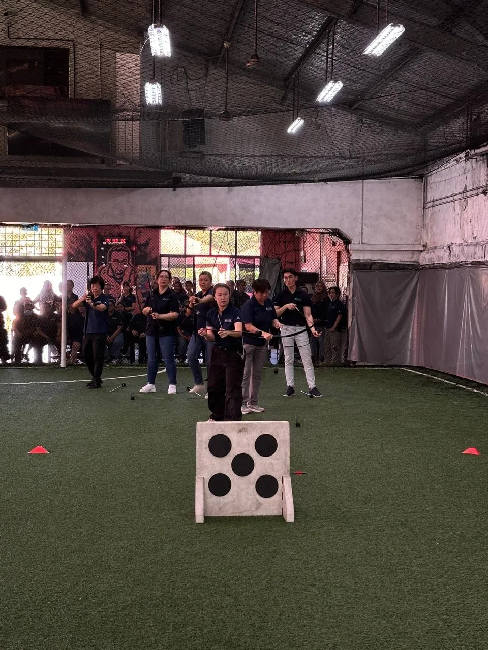 DBS team members aiming at a target during a Cohesion team-building session.