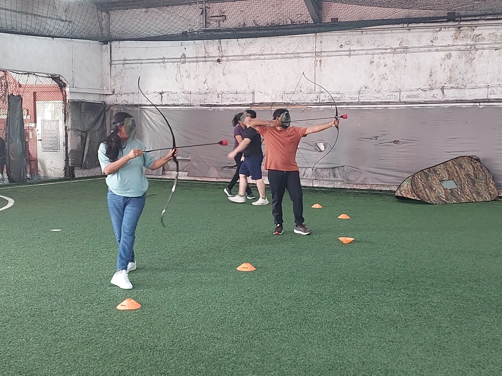 Micron team members taking part in an archery activity during a Cohesion team-building session.