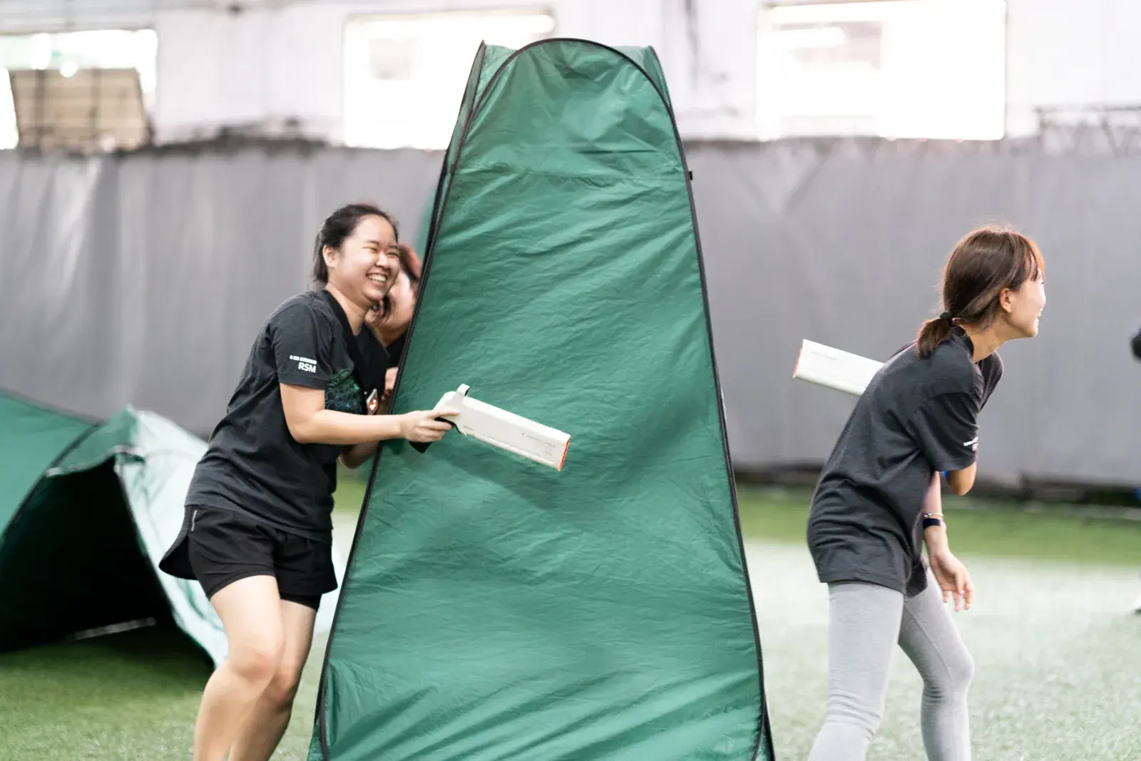 Laser Tag participants moving through a Cohesion team building activity