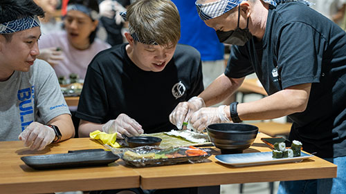 Participants preparing food during a cuisine workshop