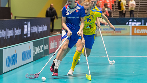 Floorball players competing during an indoor activity