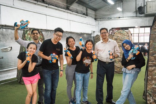 Corporate team building participants smiling during a Cohesion activity