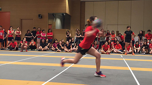 Dodgeball player moving across an indoor court
